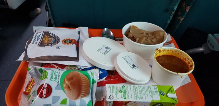 Food service in the Second-Class train - New Delhi, India. India, the most populated country on earth