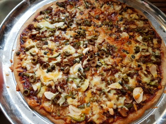 Homemade pizza, (toppings: garlic, olives,sweet peppers, hamburger meat, mushrooms and capers) with whole wheat crust. The benefits of cooking as a hobby