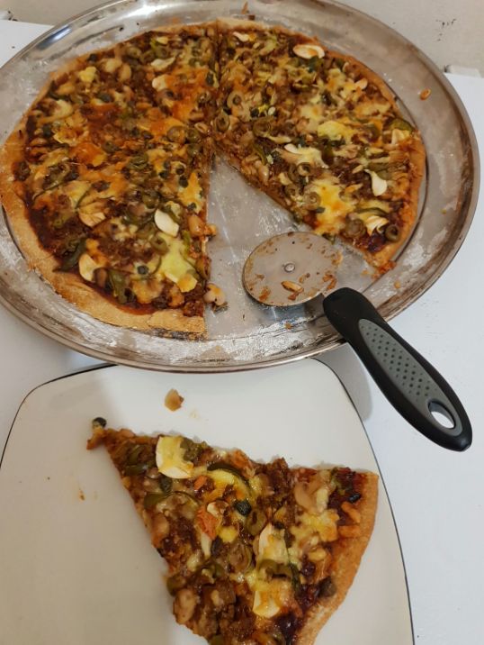 Homemade pizza, (toppings: garlic, olives,sweet peppers, hamburger meat, mushrooms and capers) with whole wheat crust. The benefits of cooking as a hobby